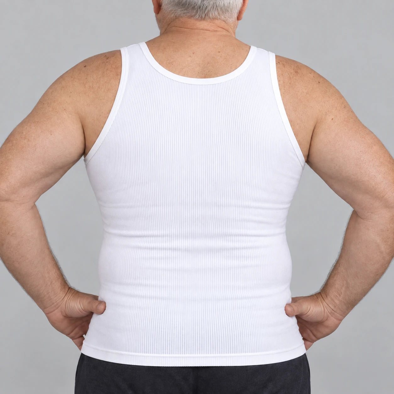 Rear view of the white compression tank showing its full back and fitted hem.